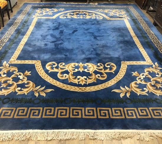 A Chinese blue ground carpet with Greek key border 480 x 365cm